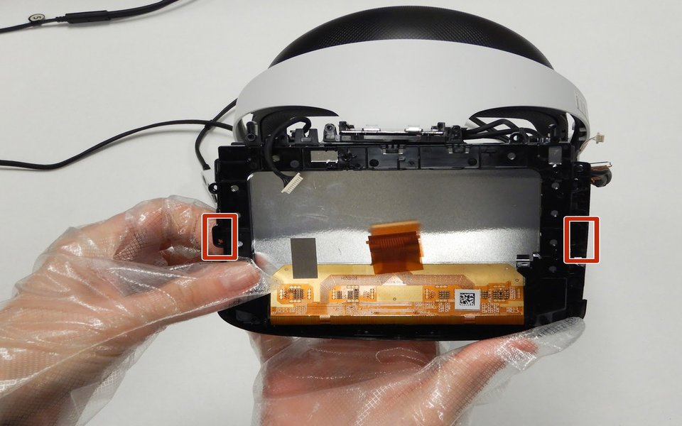 PlayStation VR circuit board handled with gloves during repair