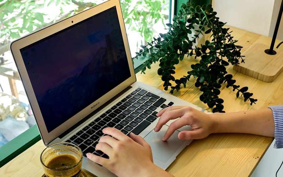 Hand using a laptop touchpad