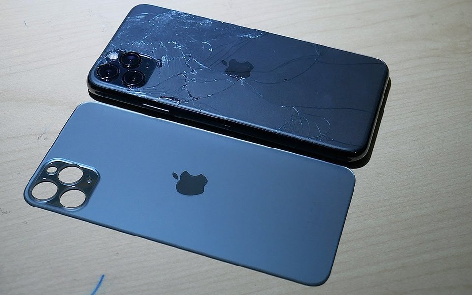 iPhone 11 Pro with cracked back glass next to the replacement back glass