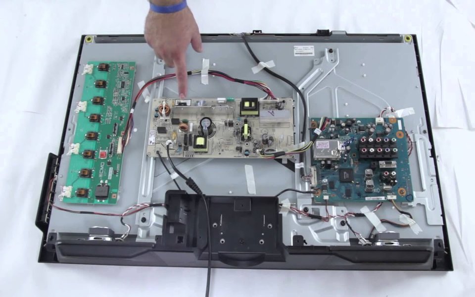 Open TV chassis with the power and main boards exposed on our bench